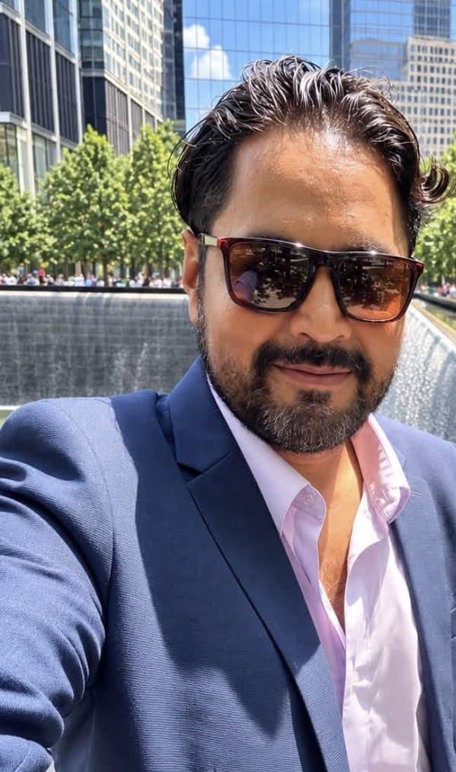 Eduardo Ramos in a navy blazer in Lower Manhattan, New York