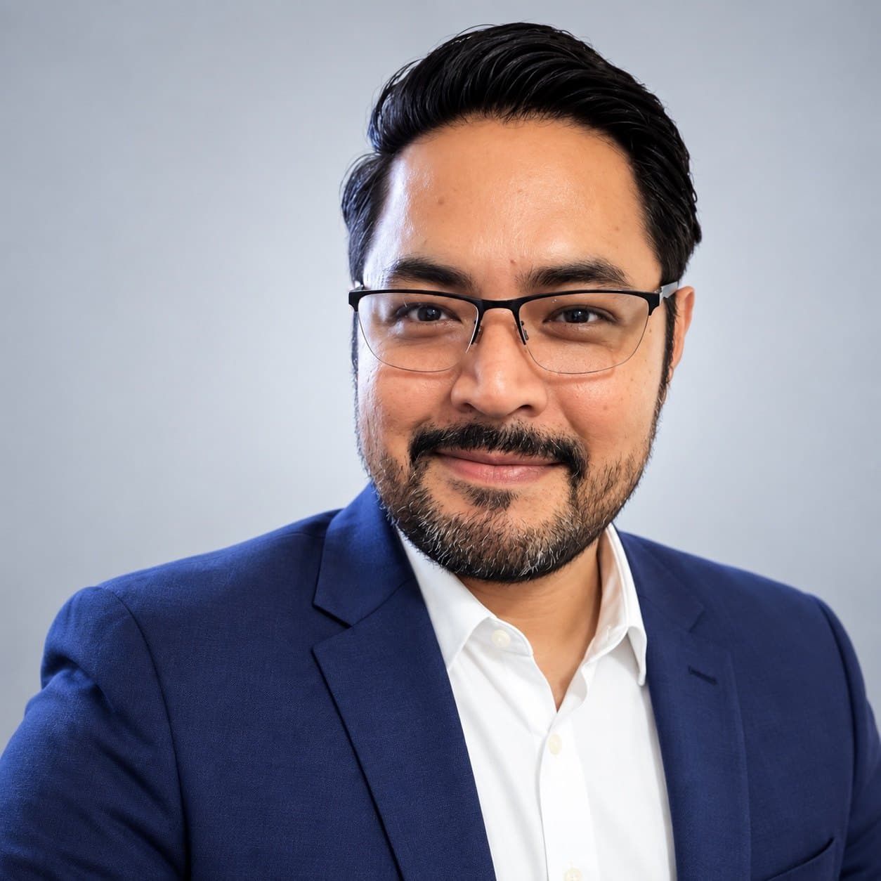 Eduardo Ramos, professional portrait in a navy suit and white shirt