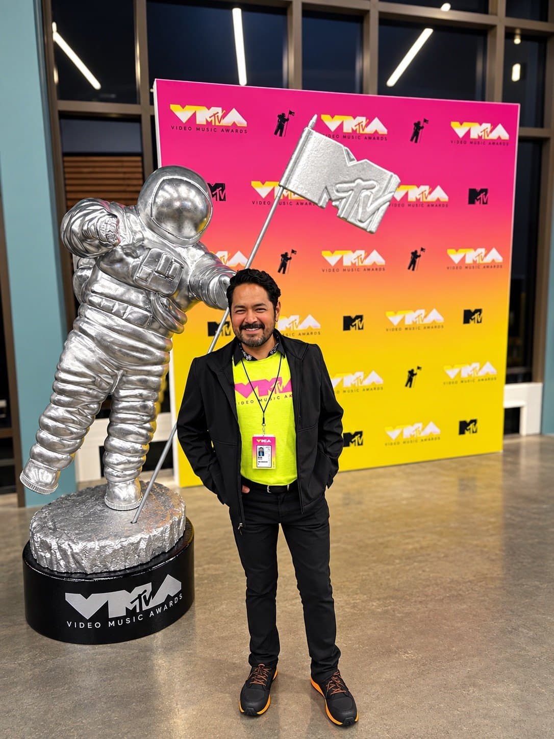 Eduardo Ramos with event credential beside the MTV Video Music Awards Moonman